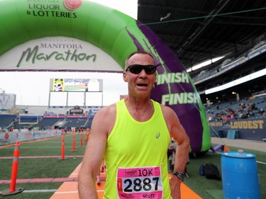 East Selkirk resident and Selkirk Comp athletic director Scott Gurney crosses the finish line after completing the 10 kilometre run at the 41st annual Manitoba Marathon in Winnipeg, Man., on Sunday, June 16, 2018.