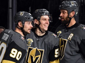 Golden Knights Erik Haula, centre, is flanked by teammates Tomas Tatar, left, and Deryk Engelland after he assisted Tatar on a goal against the Vancouver Canucks in the second period of their game at T-Mobile Arena on March 20, 2018 in Las Vegas. (Ethan Miller/Getty Images)