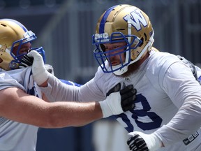 Geoff Gray (right) grabs 
a mittful of the jersey 
of Drew Desjarlais 
during Winnipeg Blue Bombers practice at IG Field on Monday.  Kevin King/Winnipeg Sun