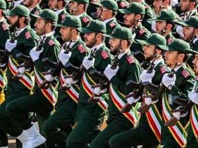 In this file photo taken on Sept. 22, 2018 members of Iran's Revolutionary Guards Corps (IRGC) march during the annual military parade marking the anniversary of the outbreak of the devastating 1980-1988 war with Saddam Hussein's Iraq, in the capital Tehran.