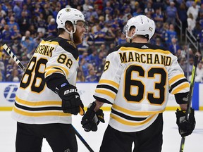 Boston Bruins right wing David Pastrnak (88) and left wing Brad Marchand (63) celebrate a goal against the St. Louis Blues during Game 6 of the Stanley Cup final at Enterprise Center. (Jeff Curry-USA TODAY Sports)