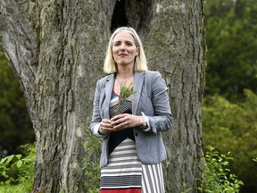 Minister of Environment and Climate Change Catherine McKenna holds a sapling that she received after making an announcement, on World Environment Day at the Dominion Arboretum in Ottawa on Wednesday, June 5, 2019. (THE CANADIAN PRESS/Justin Tang)