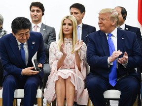 Prime Minister Justin Trudeau (back row, left), Japan's Prime Minister Shinzo Abe (front row, left), U.S. President Donald Trump (right), and adviser to the President Ivanka Trump (centre) attend an event on women's empowerment during the G20 Summit in Osaka, Japan, on Saturday, June 29, 2019.