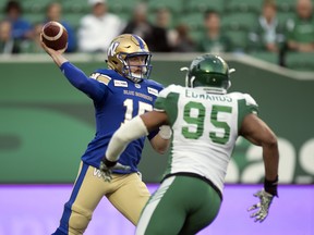 Winnipeg Blue Bombers quarterback Matt Nichols is pressured by Saskatchewan Roughriders defensive lineman Lavar Edwards  during CFL preseason action at Mosaic Stadium in Regina last night. (Troy Fleece/Postmedia)