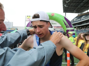 The fifth leg runner of the Marathon Relay winning team Windburn is presented with a finisher medal at the 41st annual Manitoba Marathon in Winnipeg, Man., on Sunday, June 16, 2019.