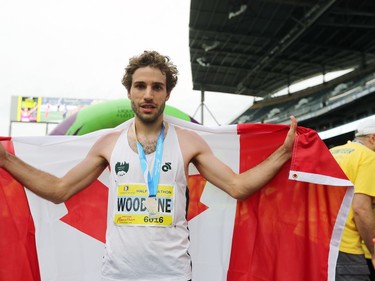Tristan Woodfine, who lives in Cobden, Ont., holds the Canadian flag after winning the Half Marathon National Championships at the Manitoba Marathon in Winnipeg, Man., on Sunday, June 16, 2019.