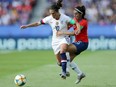 Carli Lloyd of the U.S. is challenged by Su Helen Galaz of Chile during the 2019 Women's World Cup Group F match at Parc des Princes in Paris on Sunday, June 16, 2019.
