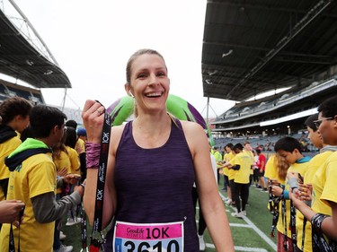 Winnipeg resident Kim Ten Krooden is all smiles after she crosses the finish line in the 10 kilometre run at the 41st annual Manitoba Marathon in Winnipeg, Man., on Sunday, June 16, 2019.