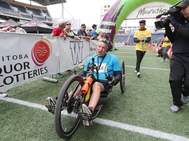Winnipeg resident Shane Hartje crosses the finish line in first place in the Men's Full Marathon Wheelchair at the 41st annual Manitoba Marathon in Winnipeg, Man., on Sunday, June 16, 2019.