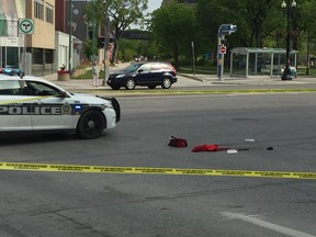 A Winnipeg Police cruiser and police tape mark off several items on Portage Avenue near Spence Street in Winnipeg on Sunday, near the scene of an assault which occurred early that morning.