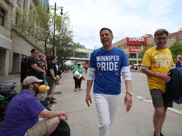 Mayor Brian Bowman (centre) and Coun. Brian Mayes walk on Portage Avenue during the annual Pride parade through the streets of Winnipeg on Sun., June 2, 2019. Kevin King/Winnipeg Sun/Postmedia Network