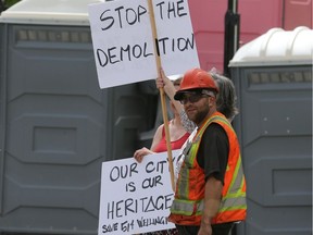 A small group of demonstrators held signs protesting a construction project in Winnipeg.  A large truck loaded up numerous toilets nearby.. Thursday, June 7/2019 Winnipeg Sun/Chris Procaylo/stf