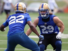Safety Jeff Hecht (right) is blocked by Chandler Fenner during a special teams drill at Winnipeg Blue Bombers practice .