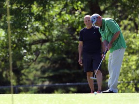 Guide Ron Oliver watches as Darcy Furber putts at Kildonan Park Golf Course on Main Street in Winnipeg, earlier this month.