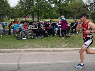 A runner passes the Marathon Band in Harrow Park during the Manitoba Marathon on Sun., June 16, 2019. Kevin King/Winnipeg Sun/Postmedia Network