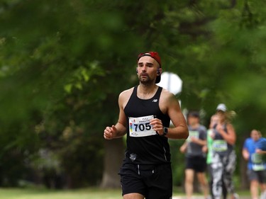 Luke Lorentz is framed by a canopy of trees as he runs along Guelph Street during the Manitoba Marathon on Sun., June 16, 2019. Kevin King/Winnipeg Sun/Postmedia Network