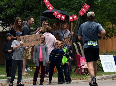 A gathering of supporters on Yale Avenue at Guelph Street fishes for high-fives during the Manitoba Marathon on Sun., June 16, 2019. Kevin King/Winnipeg Sun/Postmedia Network