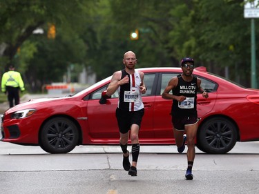 Jason Acosta (right) of New Brighton, Minn., who finished second, and Steffan Reimer of Blumenort, Man., who was fourth, cross Corydon Avenue on Guelph Street together during the Manitoba Marathon on Sun., June 16, 2019. Kevin King/Winnipeg Sun/Postmedia Network