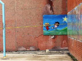 Police tape covers part of a mural at John M. King School, an elementary school on Agnes Street in Winnipeg, on Mon., June 17, 2019, where police are investigating a homicide. An adult male was shot early Monday morning. Kevin King/Winnipeg Sun/Postmedia Network