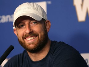 Winnipeg Blue Bombers Matt Nichols laughs while being asked about his hat, a Father's Day present from his wife reading Game Manager, during a media availability at IG Field in Winnipeg on Monday.