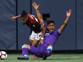 Pacific FC midfielder Matthew Baldisimo (right) appeals for a penalty as Valour FC defender Federico Pena tries to go around him near the end line during Canadian Premiere League action at IG Field in Winnipeg on Thurs., June 20, 2019. Kevin King/Winnipeg Sun/Postmedia Network