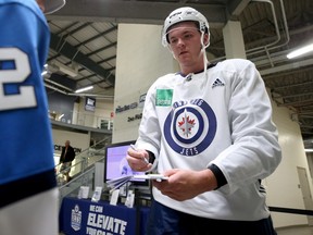 Dylan Samberg signs an autograph at Winnipeg Jets development camp at Bell MTS Iceplex on Wed., June 26, 2019. Kevin King/Winnipeg Sun/Postmedia Network