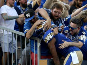 Winnipeg Blue Bombers receiver Darvin Adams is mobbed by fans while celebrating a touchdown from Nic Demski during CFL action against the Edmonton Eskimos in Winnipeg on Thurs., June 27, 2019. Kevin King/Winnipeg Sun/Postmedia Network