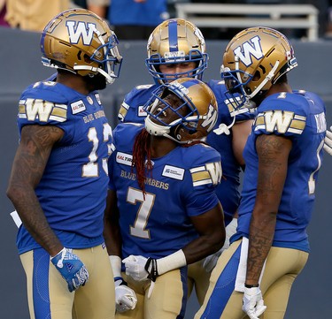Winnipeg Blue Bombers receiver Lucky Whitehead (centre) celebrates his touchdown catch against the Edmonton Eskimos during CFL action in Winnipeg with Chris Matthews (left) and Darvin Adams on Thurs., June 27, 2019. Kevin King/Winnipeg Sun/Postmedia Network
