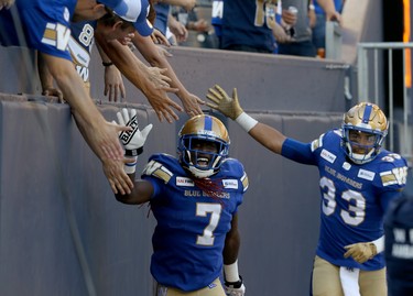 Winnipeg Blue Bombers receiver Lucky Whitehead and running back Andrew Harris celebrate a touchdown catch by Whitehead with fans during CFL action against the Edmonton Eskimos in Winnipeg on Thurs., June 27, 2019. Kevin King/Winnipeg Sun/Postmedia Network