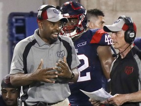 Montreal Alouettes' head coach Khari Jones, left, has a conversation with defensive coordinator Bob Slowik during game against the Hamilton Tiger-Cats in Montreal on Thursday, July 4, 2019.