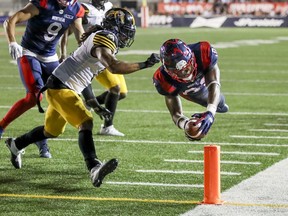 Alouettes' William Stanback dives for the end zone for a touchdown past Hamilton Tiger-Cats' Rico Murray at Molson Stadium on Thursday July 4, 2019.