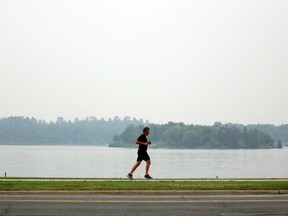 Forest fires raging near Red Lake and Manitoba made for smoky conditions in the Kenora area as this jogger heads down Lakeview Drive Saturday. Environment Canada issued an air quality advisory Friday due to the large amounts of smoke.