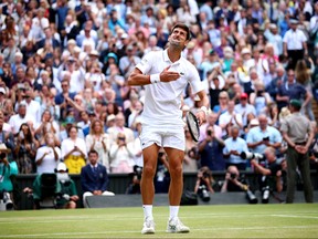 Novak Djokovic of Serbia celebrates winning the Men's Singles final against Roger Federer of Switzerland during Day thirteen of The Championships - Wimbledon 2019 at All England Lawn Tennis and Croquet Club on July 14, 2019 in London, England.