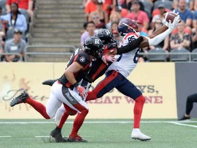 Ottawa Redblacks defensive-backs Antoine Pruneau, left, and Corey Tindal Sr. chase Montreal Alouettes wide-receiver B.J. Cunningham as he attempts to pull in a pass during first quarter CFL action Saturday, July 13, 2019, in Ottawa.