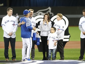 John Gibbons greets Brandy Halladay, the widow of former Blue Jays ace Roy Halladay, and his two sons in a ceremony on Opening Day in 2018.