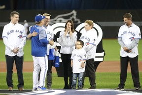 John Gibbons greets Brandy Halladay, the widow of former Blue Jays ace Roy Halladay, and his two sons in a ceremony on Opening Day in 2018.