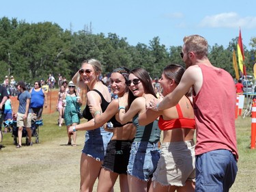 Ashton Stewart, Morgan Neitberger, Sydney James, Faith Newman and Jonas Arnbjornster help each other out by putting sunsreen on each other while they attend the 46th annual Winnipeg Folk Festival at Birds Hill Provincial Park, north east of Winnipeg, Man., on Saturday, July 13, 2019. The tempetature hit 28 degrees celsius by mid afternoon.