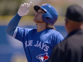 Toronto Blue Jays' Bo Bichette celebrates after an RBI single against the Canada Junior National Team Saturday, March 17, 2018, in Dunedin, Fla. (AP Photo/Jason Behnken)