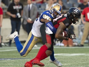 Winnipeg Blue Bombers defensive back Chandler Fenner (left) tackles Ottawa Redblacks wide receiver R.J. Harris during their game last night at TD Place in Ottawa. The Bombers won 29-14 and remain undefeated. (THE CANADIAN PRESS)