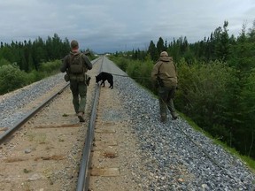 RCMP officers conduct search for two fugitive teenagers wanted in the killing of three people, including an American women and her Australian boyfriend, near Gillam in northern Manitoba, earlier this week.