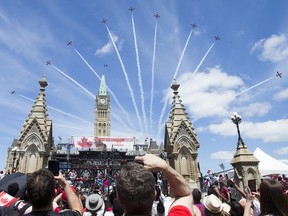 The Snowbirds fly over Parliament Hill as Canada Day activities are in full swing throughout Ottawa's downtown core on Monday, July 1, 2019.  Photo by Wayne Cuddington/ Postmedia