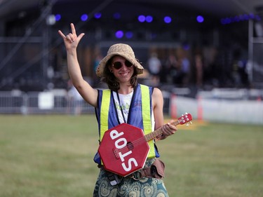 Charlotte Morin rocks a replica guitar while she volunteers as part of the safety crew at the 46th annual Winnipeg Folk Festival at Birds Hill Provincial Park, north east of Winnipeg, Man., on Thursday, July 11, 2019. The annual Winnipeg Folk Festival runs July 11 to 14, 2019.