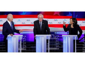 Former U.S. vice-president Joe Biden and Sen. Kamala Harris debate racial issues as Sen. Bernie Sanders listens during the second night of the first U.S. Democratic presidential candidates 2020 election debate in Miami, Fla., June 27, 2019.