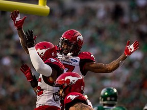 Calgary Stampeders running back Ka'Deem Carey (35), left, celebrates a touchdown with teammate Markeith Ambles (17) during first half CFL action against the Saskatchewan Roughriders, in Regina on Saturday. Photo by Matt Smith/The Canadian Press.