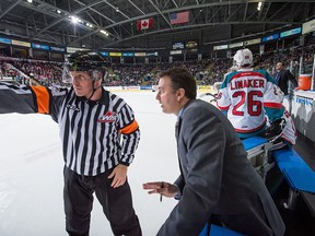 KELOWNA, CANADA - JANUARY 16: Head coach Dan Lambert of Kelowna Rockets speaks to a referee at the whistle during third period against the Seattle Thunderbirdson January 16, 2015 at Prospera Place in Kelowna, British Columbia, Canada.  (Photo by Marissa Baecker/Getty Images)
