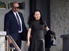 Huawei's Financial Chief Meng Wanzhou leaves her family home with a private security guard in Vancouver, British Columbia, Canada, May 8, 2019.