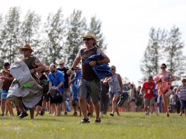 Hundreds of Folk Fest goers take part in the tarp shuffle to kick-off the 46th annual Winnipeg Folk Festival at Birds Hill Provincial Park, north east of Winnipeg, Man., on Thursday, July 11, 2019. The annual Festival runs July 11 to 14, 2019.