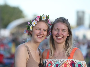 Natalie Enns and Scarlette Friesen are all smiles with the Main Stage in the background at the 46th annual Winnipeg Folk Festival at Birs Hill Provicial Park, north east of Winnipeg, Man., on Saturday, July 13, 2019.