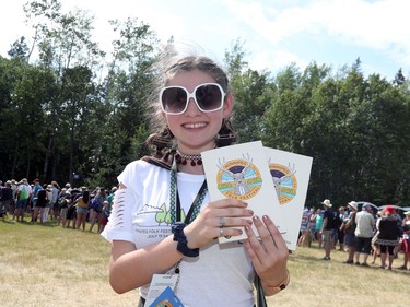 Volunteer Leah Noel shows off the official program for the 46th annual Winnipeg Folk Festival at Birds Hill Provincial Park, north east of Winnipeg, Man., on Thursday, July 11, 2019. The annual Festival runs July 11 to 14, 2019.