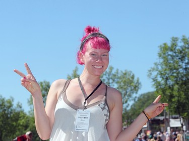 Volunteer Ysi Pinola gives peace signs as she shows off her vibrant hair colour during the final day of the 46th annual Winnipeg Folk Festival at Birds Hill Provincial Park, north east of Winnipeg, Man., on Sunday, July 14, 2019.